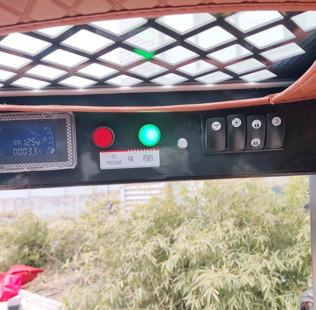 Control panel with a green power indicator, a red push button, and switches labeled Oil Pressure, Fan, Power; gauge on the left.