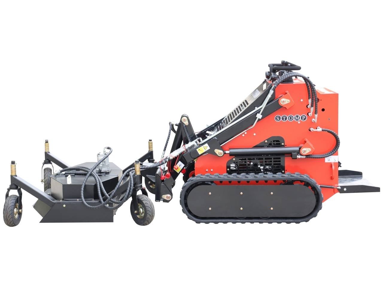 Red tracked stump grinder with a hydraulic lifting arm used to grind tree stumps, attached to a transport cart/implement system.