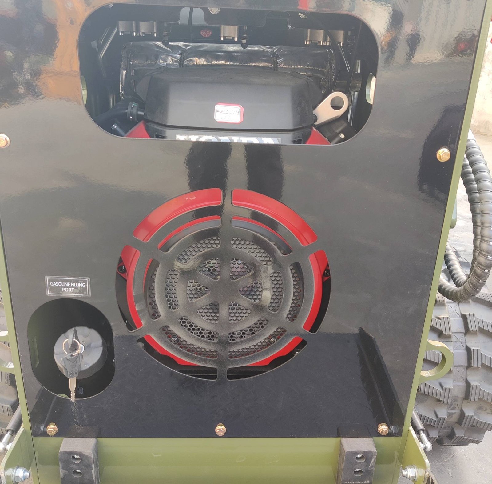 Rear view of a gas-powered engine compartment with a prominent red-ringed cooling fan and fuel port labeled ‘Gasoline Filling Port’